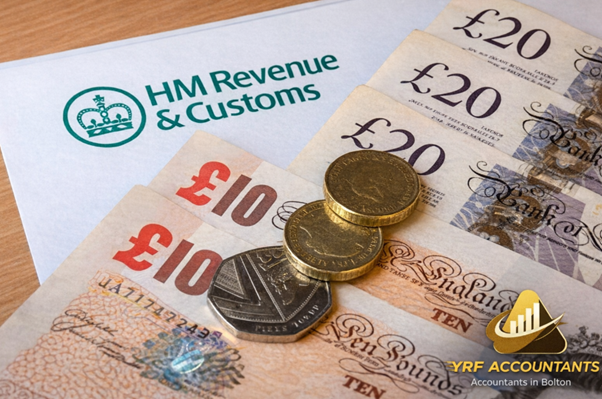 British pound banknotes and coins placed on an HMRC letter with YRF Accountants logo, illustrating UK tax and finance guidance by Accountants Bolton.